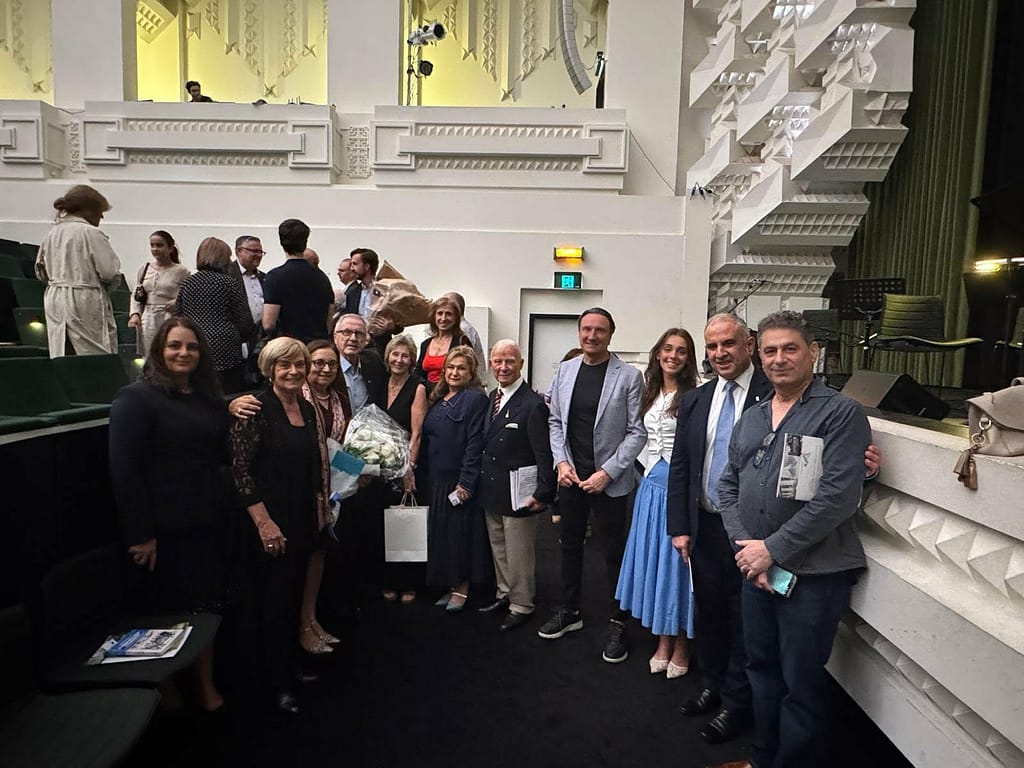 Professor Anastasios Tamis, an inspiration of the event, surrounded by supporters and guests at the Capitol Theatre